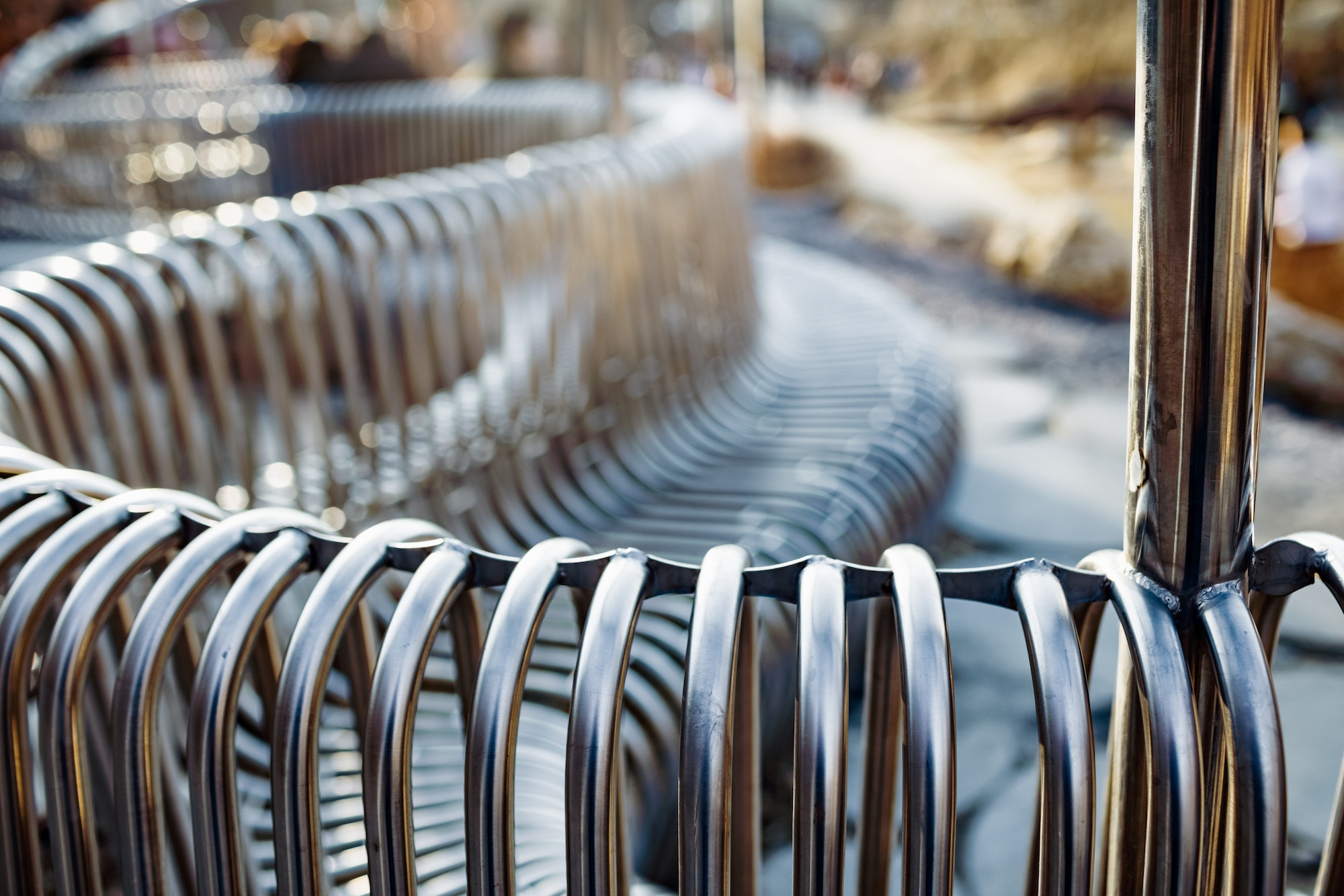 Close-up street bench metal pipes arranged parallel